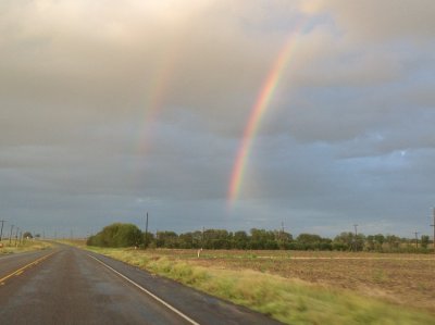 Driving along our country highway and seeing this double rainbow.  What we noticed was that the color patterns between them are reversed.