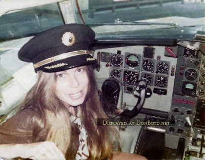 1974 - Debbie Cicirelli, National Airlines Flight Attendant, in the captain's seat of a National B727