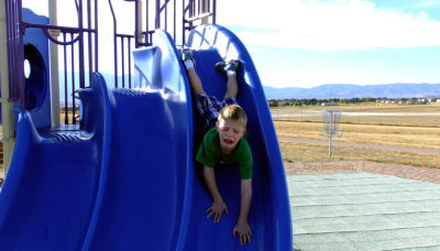 October 2014 - Kyler on the playground slide at Peterson Air Force Base