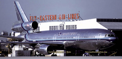 1986 - Eastern Airlines DC10-30 N390EA waiting to cross runway 9L-27R from their maintenance base to the terminal