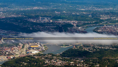 2015 - closeup of downtown Pittsburgh which is obscured by a solitary low cloud