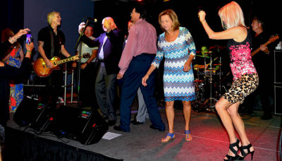 HHS-66 50-Year Reunion and Reunion of the 60's: classmates singing and dancing on stage with the band