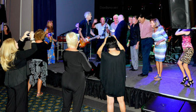 HHS-66 50-Year Reunion and Reunion of the 60's: classmates singing and dancing on stage with the band