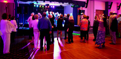 HHS-66 50-Year Reunion and Reunion of the 60's: classmates watching classmates singing and dancing on stage with the band