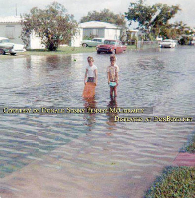 Early 1960's - two young boys playing on a flooded Hialeah street