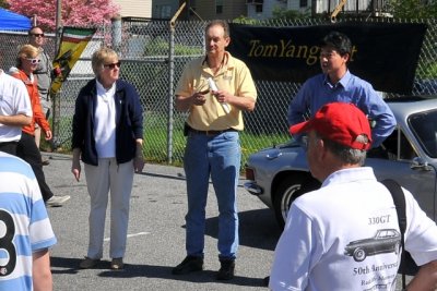 Radcliffe Motorcar Co. owner Richard Garre, in yellow, speaks to participants and spectators. (9741-c)