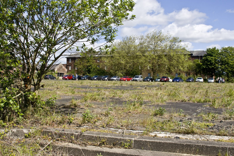 Parade Ground being used as a car park with the PO's Mess behind the trees.