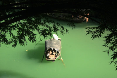 boat with black tarpaulin cover on dragon stream.jpg