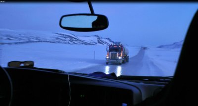 Truck crossing on icy road. Cars have to yield to trucks...