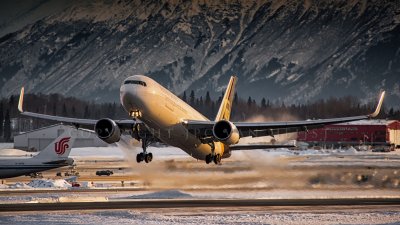 UPS 767 taking off at sunset