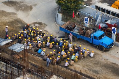 North Korean workers singing before construction works