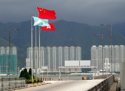 Chinese and Hong Kong Flag with Coastal Skyline Buildings.jpg
