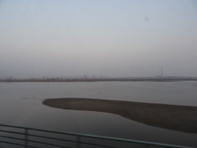Pyongyang and East Pyongyang Thermal Station from Mangyongdae Bridge.jpg