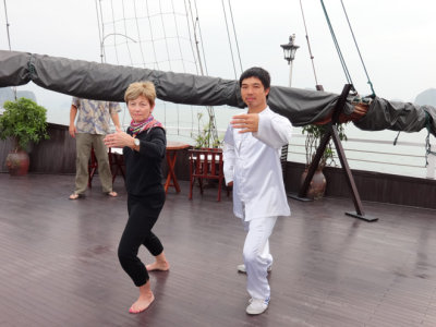 Janet learning T'ai Chi aboard the Treasure Junk in Ha Long Bay, Vietnam