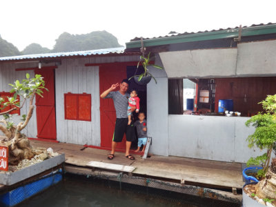 A father with his children - a house in the floating village of Ha Long Bay, Vietnam