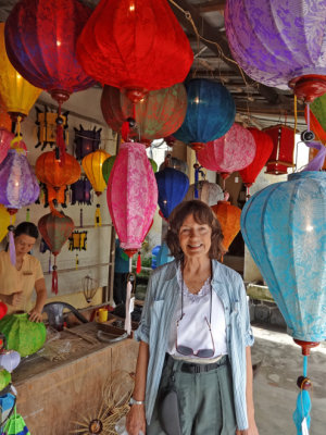 Judy among the beautiful and brightly colored silk lanterns produced at the Thang Loi Company, Hoi An, Vietnam