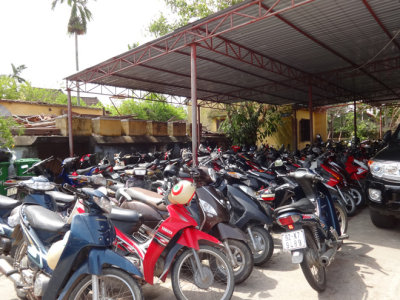 Parking lot of the Thang Loi Company showing scooters and motorcycles - common transportation in Vietnam - Hoi An , Vietnam