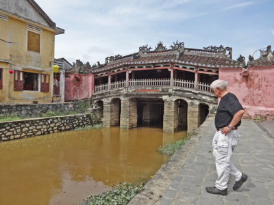 Stan near the Japanese Bridge and a canal of the Thu Bon River - Old Town, Hoi An, Vietnam 