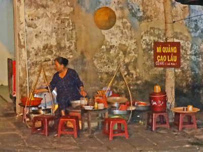 Outdoor restaurant - customers sit on the stools - Hoi An Vietnam