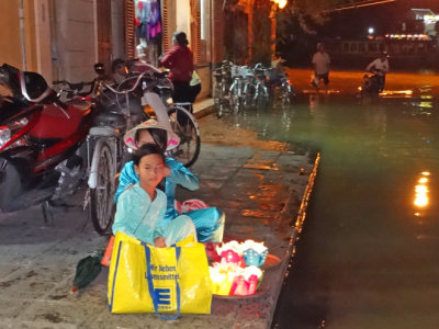 The Thu Bon River often floods (as shown here) - vendors (foreground) selling candles to float on the river - Hoi An, Vietnam