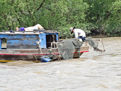 Fishermen on the My Tho River - photo taken while we were going by boat to a nearby island - Mekong Delta, Vietnam
