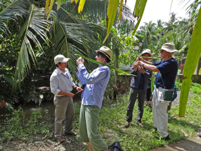 Sally and Stan - crafts lessons using large palm tree leaves - on an island near My Tho in the Mekong Delta, Vietnam