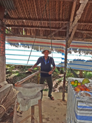 A worker involved in food preparation - on an island near My Tho in the Mekong Delta, Vietnam