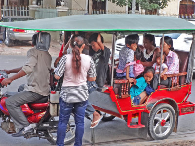 Cambodian families being transported by tuk-tuk - Phnom Penh, Cambodia
