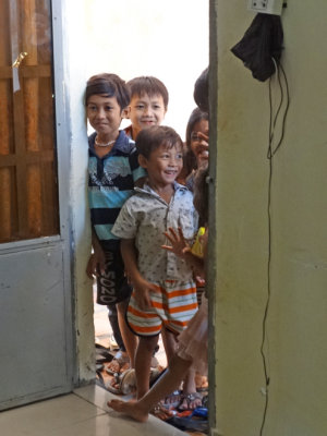 Children peaking in the door of the room of several of our sponsored young ladies (college students) - Phnom Penh, Cambodia