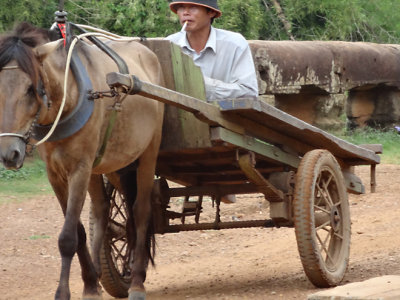A farmer in his horse cart on the Spean Praptos Bridge - connecting Angkor to Phnom Chisor, Cambodia 