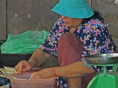A woman preparing food at the Old Market in Siem Reap, Cambodia