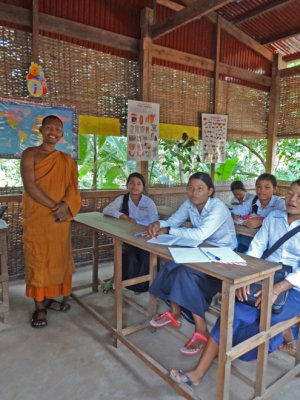 Class of young Cambodians learning English from a Hindu monk.