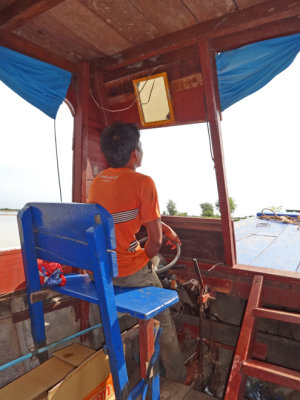 The captain of our boat - while exploring the floating village on Tonle Sap Lake in the Siem Reap Province of Cambodia