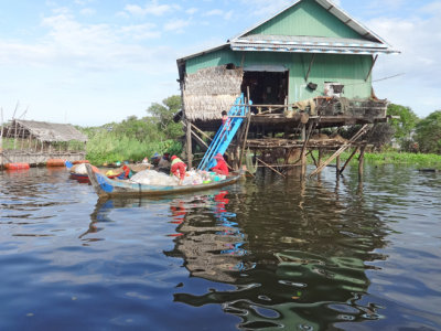 House (on stilts/piles) and boat in a stilted village on Tonle Sap Lake in the Siem Reap Province of Cambodia