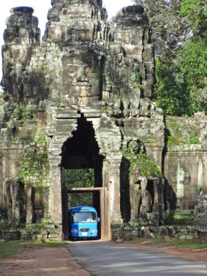 A bus squeezing through the East gate entrance to the walled city of Angkor Thom - Siem Reap Province, Cambodia