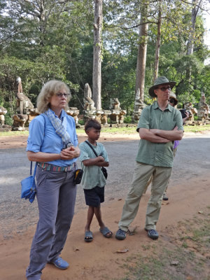Stacy and Alan joined by a local onlooker while viewing the statues on the road to Angkor Thom - Siem Reap Province, Cambodia
