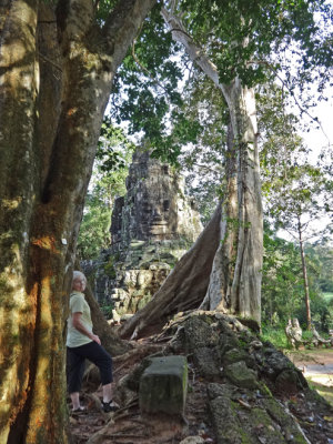 Helen viewing the face on a shrine while she was walking to the center of Angkor Thom - Siem Reap Province, Cambodia