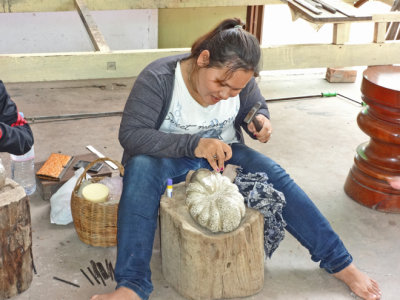 An artisan preparing an item for sale at the stores located at our unscheduled shopping stop - Siem Reap Province, Camodia