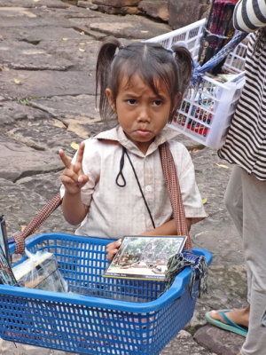Cute little girl selling souvenirs - while we were walking on a road to Preah Khan, Angkor, Siem Reap Province, Cambodia