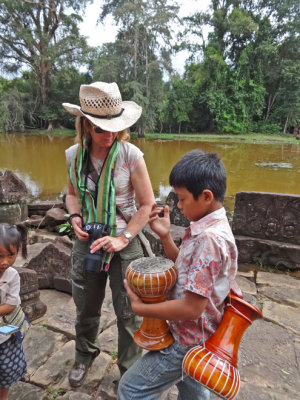 Fran & boy discussing his souvenir drums for sale -  while we were walking on a road to Preah Khan, Angkor, Siem Reap, Cambodia
