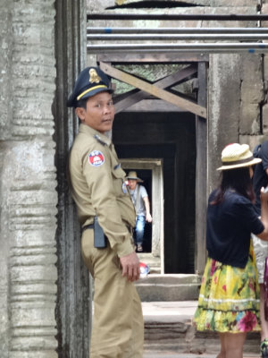 A police officer providing security at Preah Khan - Angkor, Siem Reap Province, Cambodia