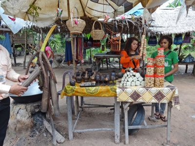 A woman preparing palm sugar (for sale) - on our way back to Siem Reap from Banteay Srei - Siem Reap Province, Cambodia 