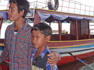 A man and his son in a floating village on Tonle Sap Lake - Siem Reap Province, Cambodia