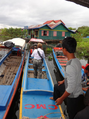 Janet getting on a shallow-bottom boat to visit Prek Toal, a bird sanctuary - Tonle Sap Lake, Siem Reap Province, Cambodia