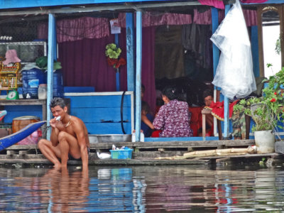 A guy brushing his teeth at a floating house, Tonle Sap Lake, Siem Reap Province, Cambodia