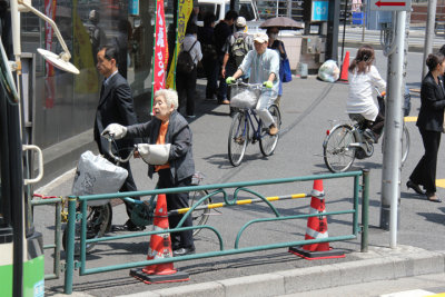 Bicyclists in Akihabara (Electric Town) - district in central Tokyo famous for its electronic, manga and anime shops