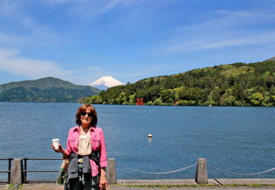 Judy at the Moto-Hakone port with Mt. Fuji, the red torii gate of the Hakone Shrine and Lake Ashi in the background