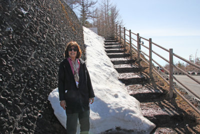 Judy with snow at the stairs of a hiking trail on Mt. Fuji - at the Fuji Subaru Line 5th Station