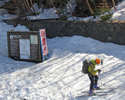 A skier (perhaps an official?) who just finished exploring Mt. Fuji - at the Fuji Subaru Line 5th Station