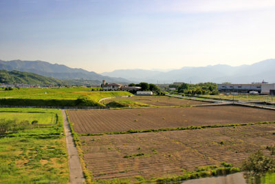 Farmland and mountains as seen while traveling from Owakudani to Suwa-shi 